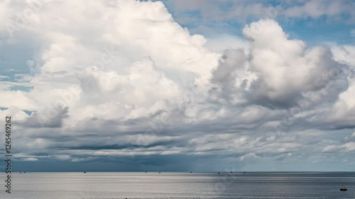 Cloudscape Evolution Over Calm Sea. Majestic Clouds Drifting Gracefully Over Tranquil Sea Waters. photo