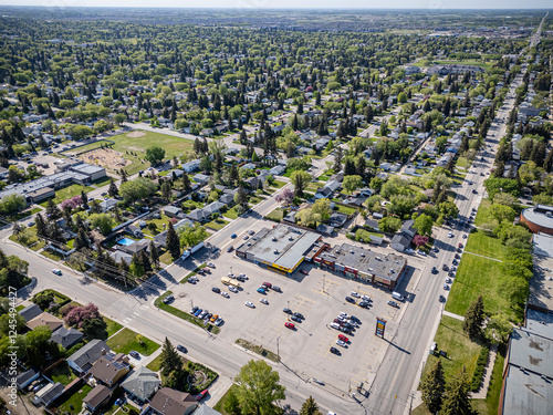 City street with a large shopping center in the middle photo