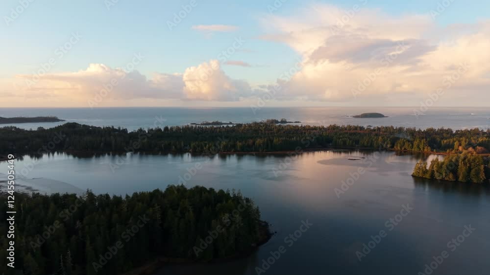 Drone shot of Tofino on Vancouver Island displaying autumn colors, rugged coastline, and ocean waves in a scenic aerial view. Drone shot of Tofino on Vancouver Island displaying autumn colors, rugged coastline, and ocean waves in a scenic aerial view.