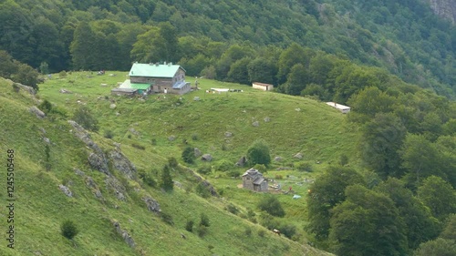 Rai Hut in the Stara Planina Mountain. At the foot of Raisko Praskalo waterfall. Mountain Lodge. Paradise Chalet. Small chapel next to the hut. View from above. photo