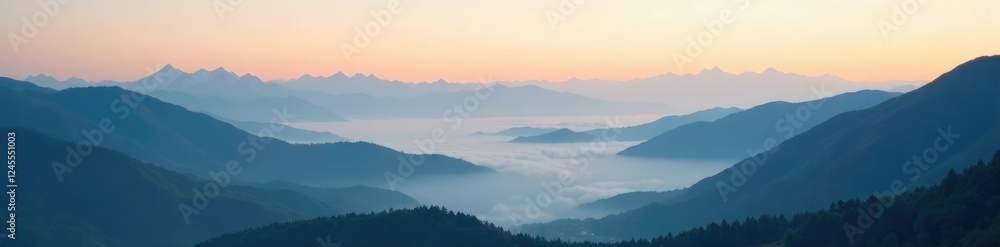Fototapeta premium Misty morning light creeps over the mountain peaks with cloudy valleys below, serene, sky, valley