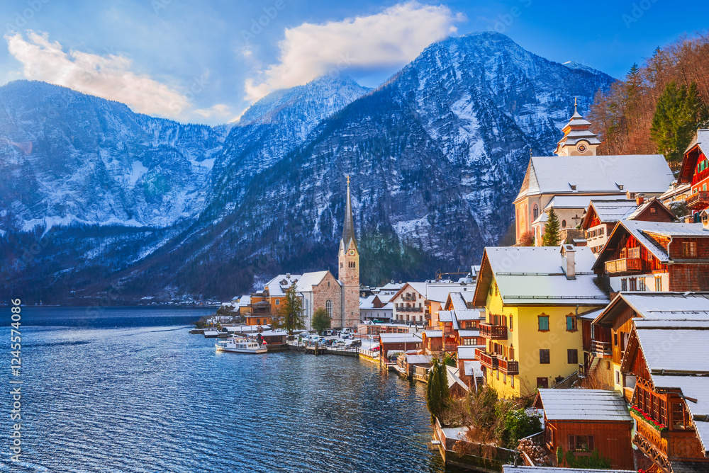 Hallstatt, Austria. Idyllic Alpine village snow-covered, serene lake, majestic mountains and sunny winter charm, Upper Austria.