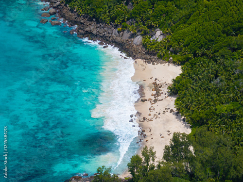 An unspoilt sandy beach in the middle of a rainforest. Seychelles, Mahe. Anse Capucins beach. photo