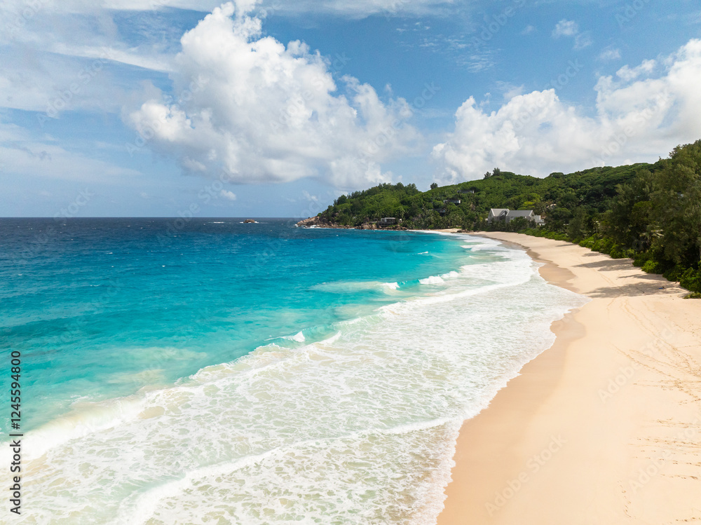 Fototapeta premium This beach features soft, beige sand that slopes gently into the azure waters of the bay. Seychelles, Mahe. Anse Intendance beach.