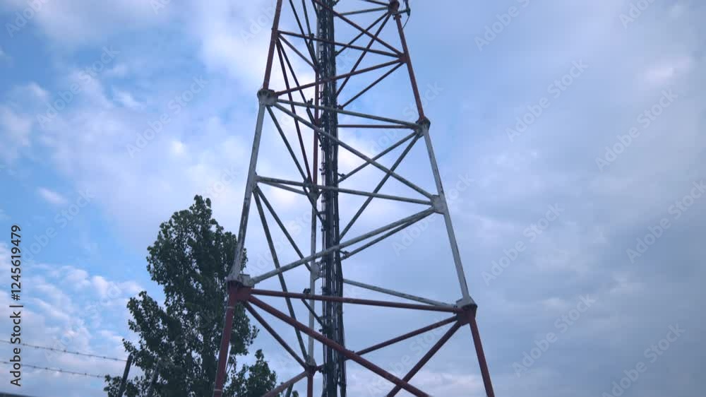 Antenna Telecommunication cell phone, radio transmitters of cellular 5g 4g mobile, smartphones, television and internet. View from the bottom up. Blue sky with white clouds Antenna Telecommunication cell phone, radio transmitters of cellular 5g 4g mobile, smartphones, television and internet. View from the bottom up. Blue sky with white clouds