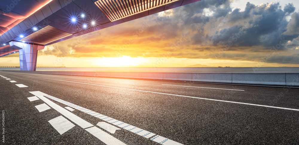 Asphalt road and bridge with beautiful coastline scenery at sunset. Outdoor road background.