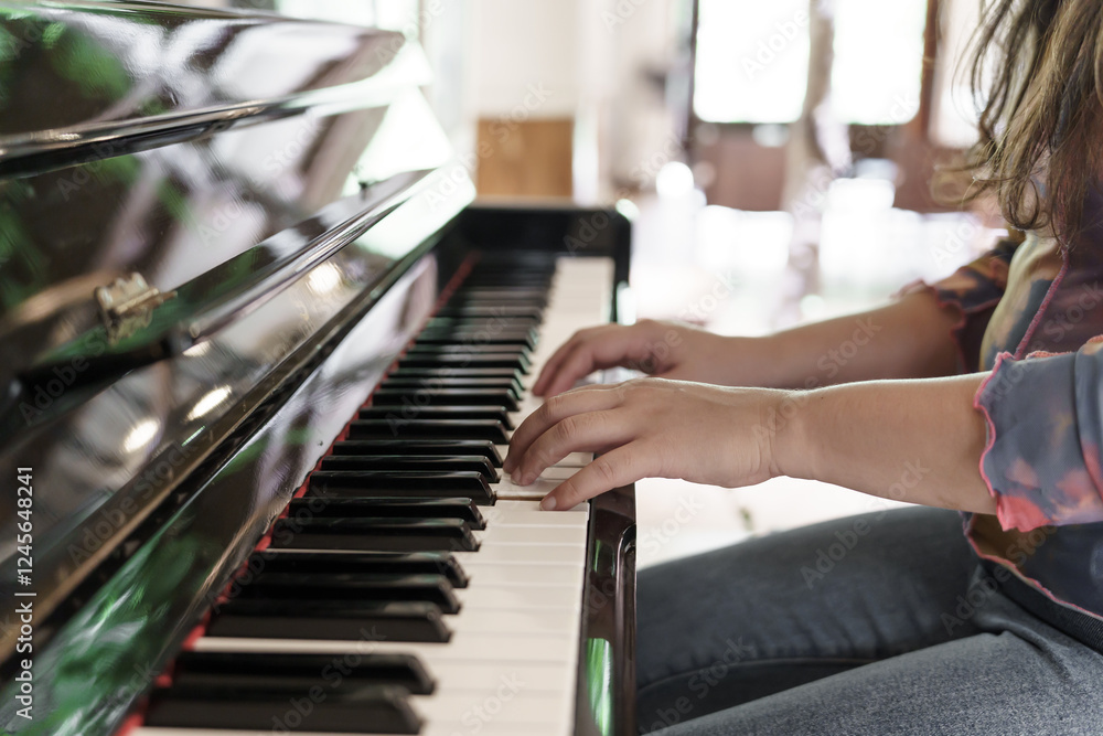 Fototapeta premium Girl learn to play piano.&nbsp;woman hand playing piano .