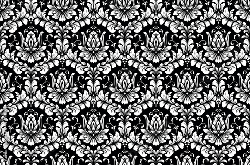 Wallpaper in the style of Baroque. White and black floral ornament. Seamless vector background. Graphic pattern for fabric, wallpaper, packaging. Ornate Damask flower illustration.