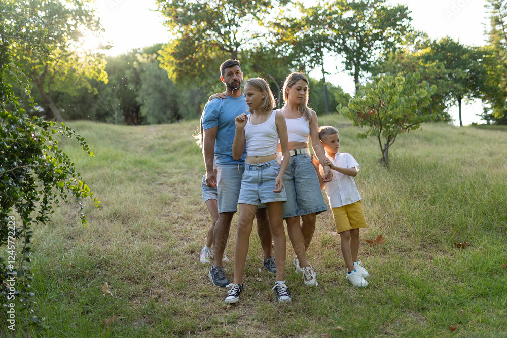 Fototapeta premium Family taking a walk together in nature on a summer day