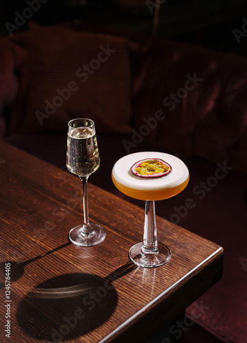 Cocktails on a wooden table with elegant glasses in a cozy lounge setting during the evening