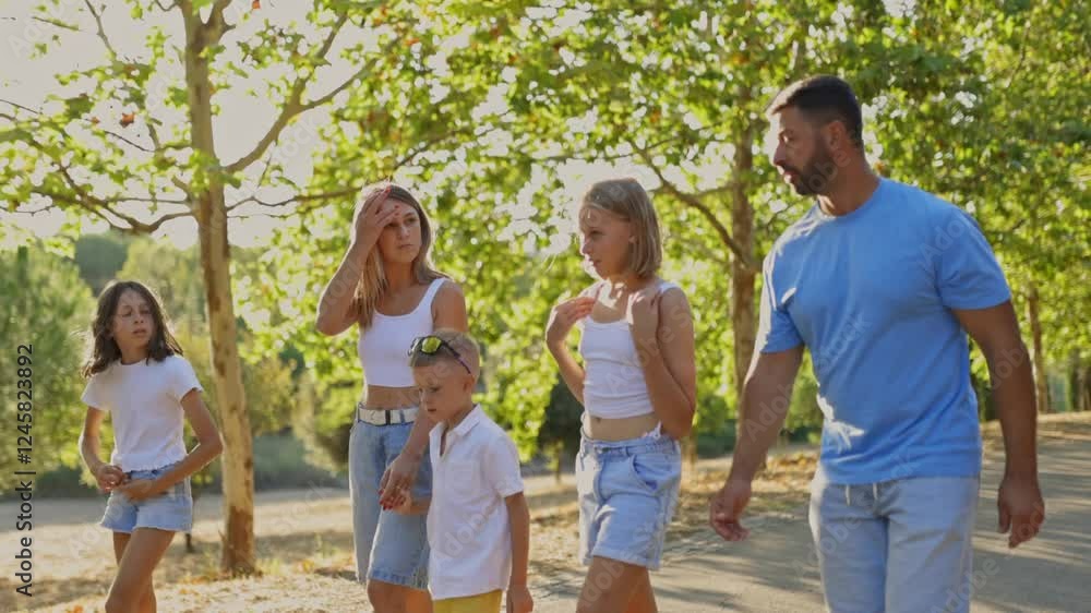 Family enjoying a walk together in a park Family enjoying a walk together in a park