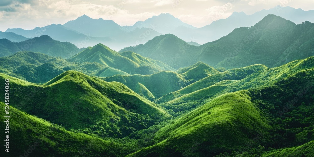 Lush green mountain range with rolling hills in bright green tones under a soft cloudy sky providing ample copy space on the right side Lush green mountain range with rolling hills in bright green tones under a soft cloudy sky providing ample copy space on the right side