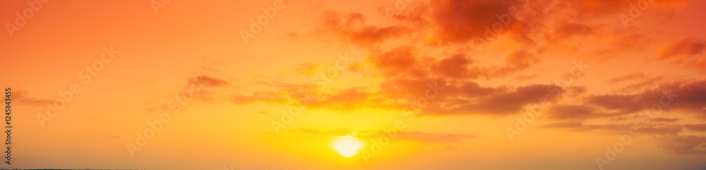Obraz premium Panorama of the orange cloudy sky during sunset. View from above. Horizontal banner