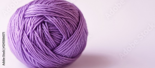 Purple yarn ball for knitting and crafts on a clean white background ideal for creative projects and textile design inspirations photo