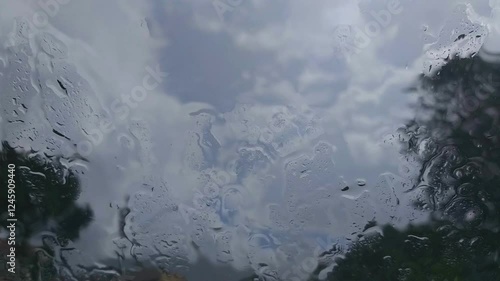 Watching the rain through the glass window.