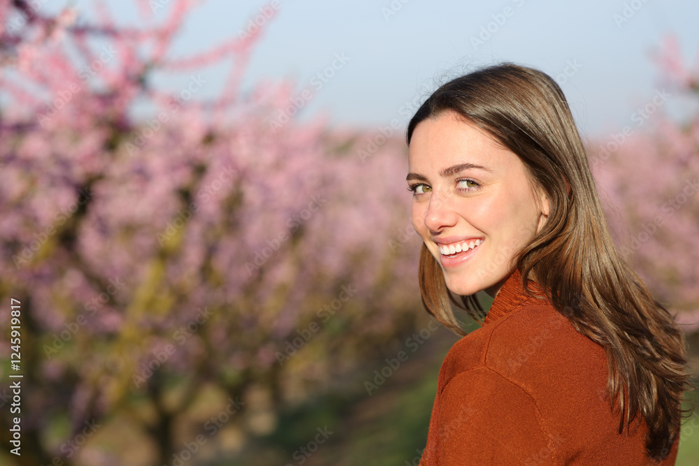 Happy woman looks at camera in a field Happy woman looks at camera in a field