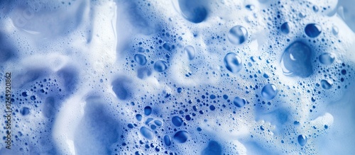 Vibrant blue frothy sea water surface creating a natural background for designs and decor with texture and depth.