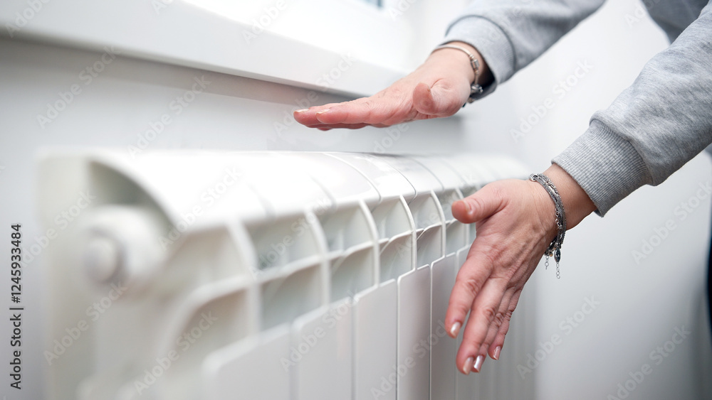 Woman heating on a chilly winter day, energy and gas crisis, cold room, heating problems.