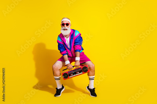 Full size photo poster of handsome granddad sportsman hold boom box dance wear vintage sportswear isolated on yellow color background photo