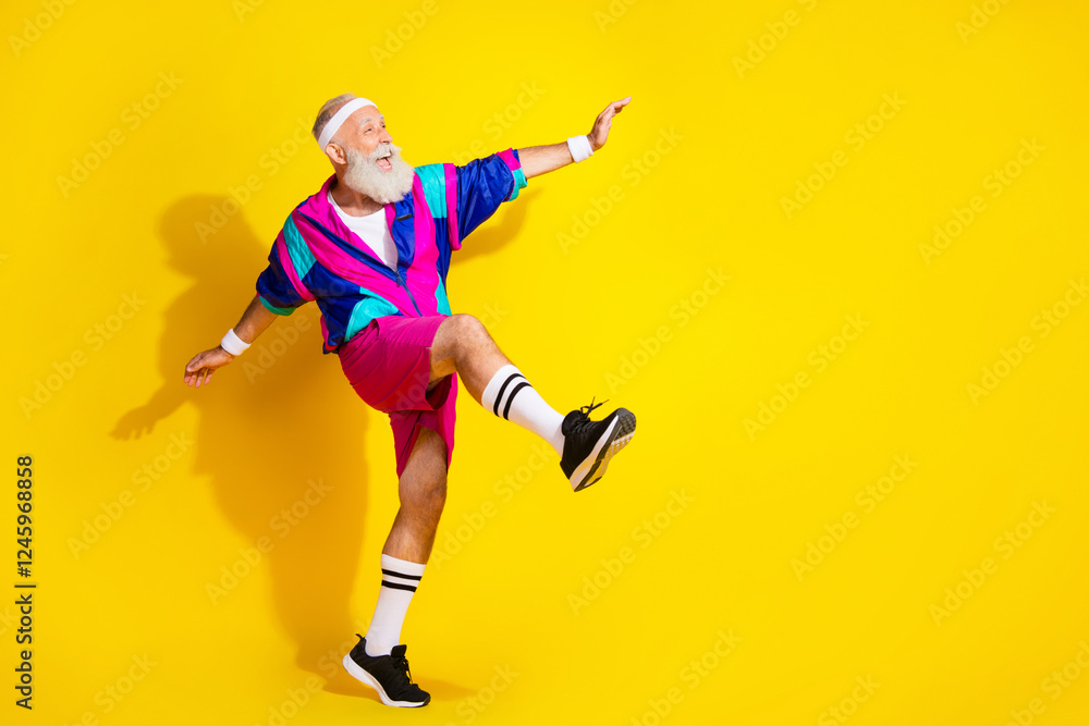 Full length photo of attractive funny retired sportsman retro sportswear dancing emtpy space isolated yellow color background Full length photo of attractive funny retired sportsman retro sportswear dancing emtpy space isolated yellow color background