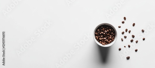 Cup overflowing with coffee beans on a minimalist white background showcasing the rich texture and aroma of fresh coffee. photo