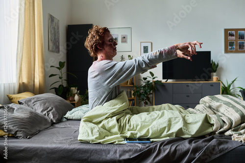 Schilderij op canvas Young Male Zombie Getting Up In Morning