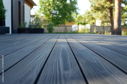 Modern Gray Composite Decking in Sunlit Backyard with Trees and Greenery