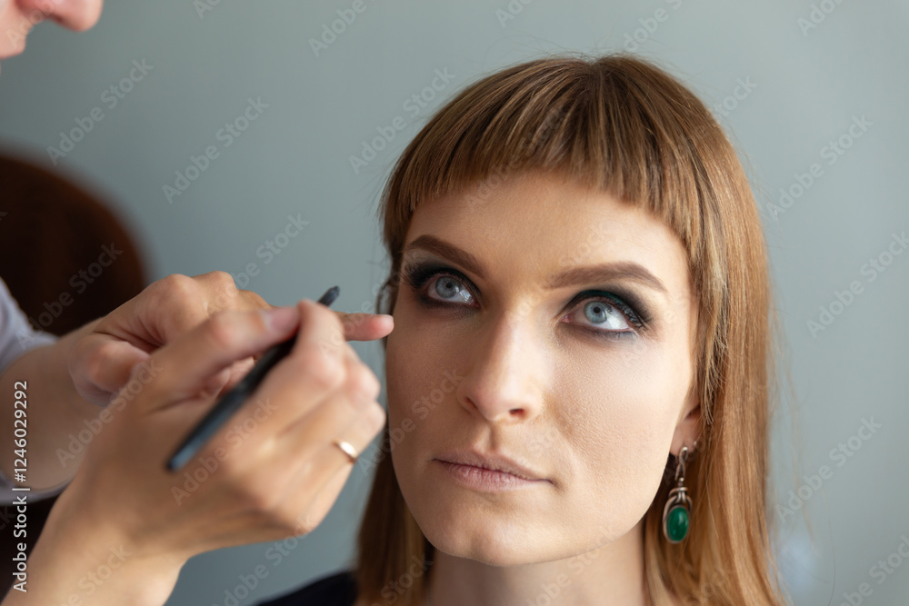 Makeup artist applying false eyelash. Makeup artist applying false eyelash.