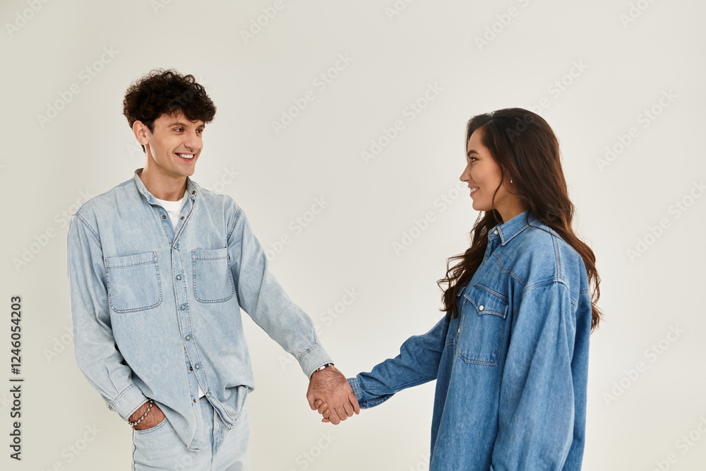 Young and stylish couple sharing a joyful moment in trendy denim outfits Young and stylish couple sharing a joyful moment in trendy denim outfits
