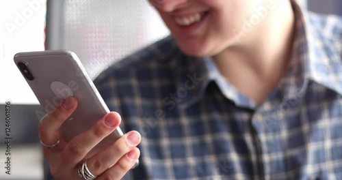 woman's hands scroll mobile phone keypad to check messages, texting, correspond and laughing at home in evening
