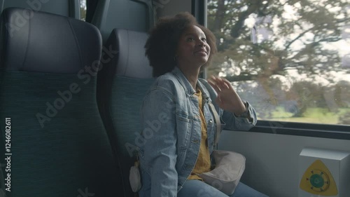 African American girl meeting up with her boyfriend on the train, greeting by kissing, and moving on a journey together, handheld shot.