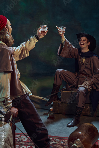 Two pirates raising their glasses in victorious toast. Their expressions are joyous, celebrating conquest and survival. Concept of brotherhood and triumph, historical portrait and adventure photo