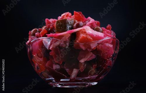 Vinaigrette salad in a glass bowl on a dark surface. Russian salad. photo