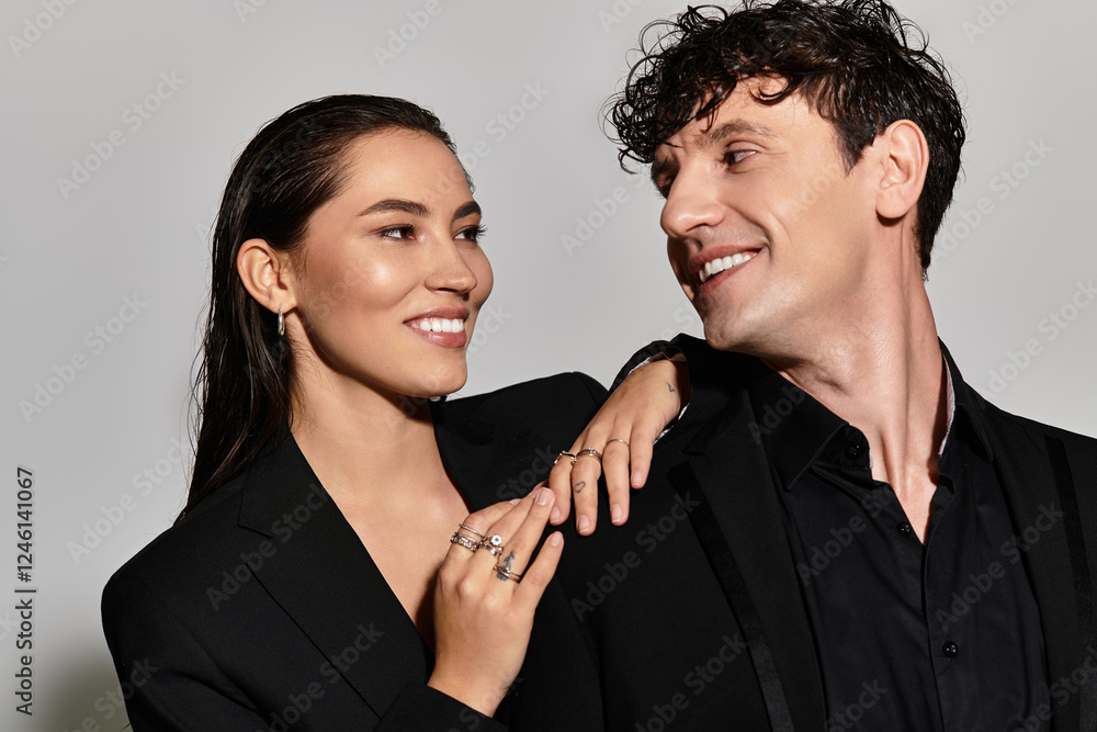 A stylish young couple shares a moment of joy, showcasing modern fashion in a sleek urban setting A stylish young couple shares a moment of joy, showcasing modern fashion in a sleek urban setting
