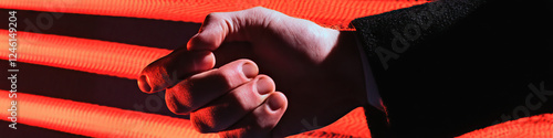 Clenched Hand Against Red Linear Background