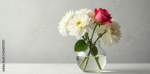 Wallpaper Mural Single stem of rose lies among lush white chrysanthemum blooms in a clear glass vase filled with water, rose, vase Torontodigital.ca