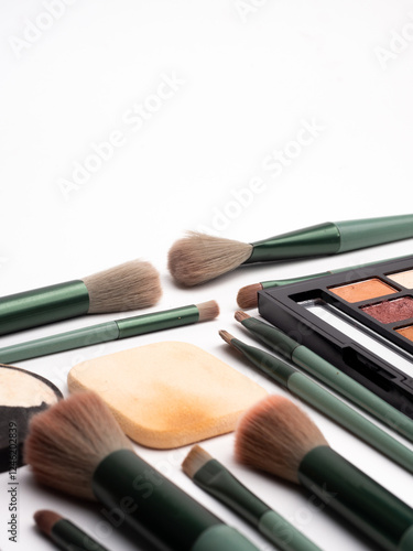 Detail Stylish green theme makeup brushes with cosmetic, flat lay. Space for text
Professional decorative cosmetics, make-up products and accessories, Eyeshadow,liptint, concealer Makeup photo