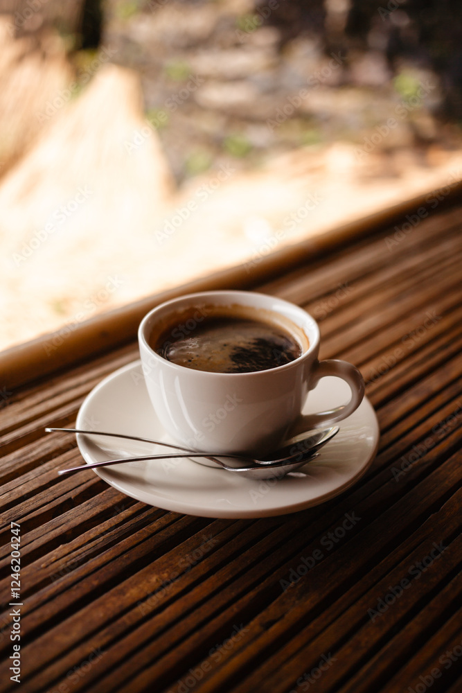 Hot Americano in a white mug on a table made of natural bamboo. Hot Americano in a white mug on a table made of natural bamboo.