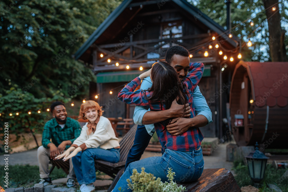 Fototapeta premium Friends enjoying a cozy evening outdoors
