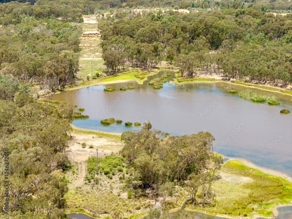 Aerial View from a drone of a landscape lake overlooking the trees out near Emmaville, NSW, Australia Aerial View from a drone of a landscape lake overlooking the trees out near Emmaville, NSW, Australia