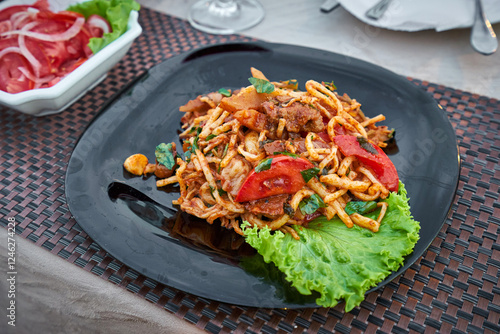 Traditional uzbek lagman on a plate photo