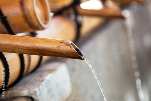 Chozuya or temizuya for the purification ceremony with bamboo pipes and running water at Fushimi-inari Shrine in Kyoto photo