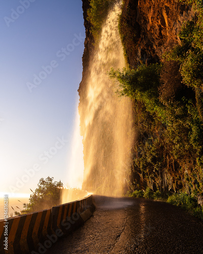 Sunset reflecting in the waterfall Cascata dos Anjos in Madeira, Portugal