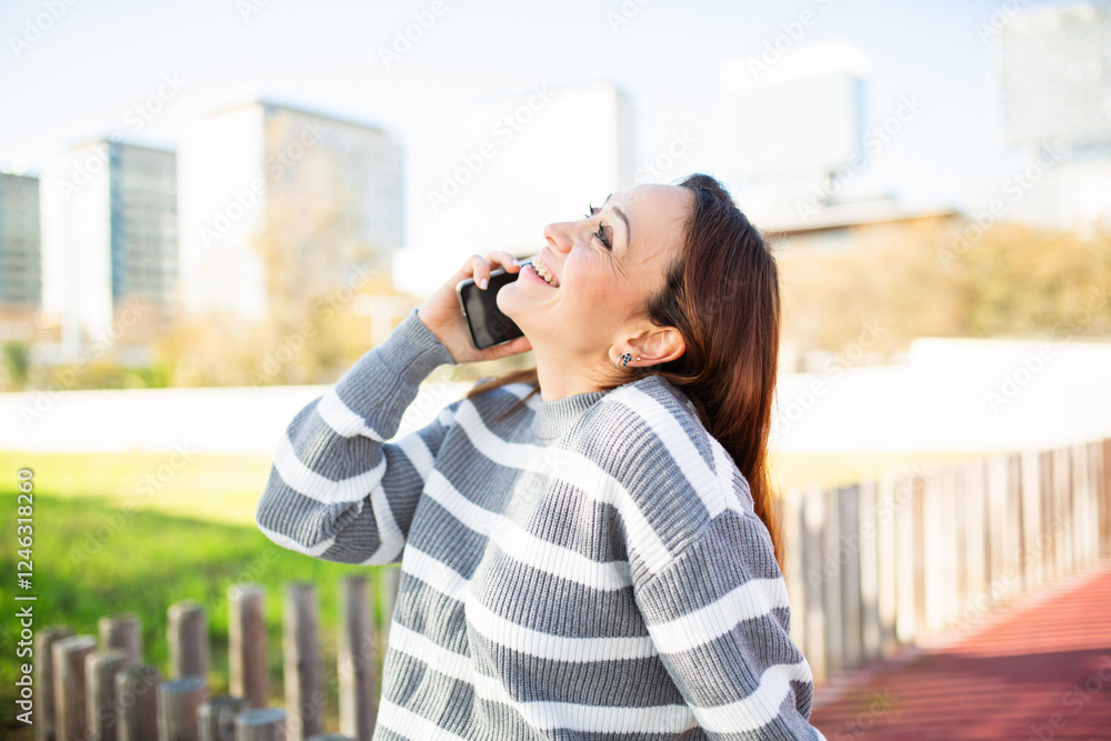 Young woman talking on smartphone outdoors in urban park Young woman talking on smartphone outdoors in urban park