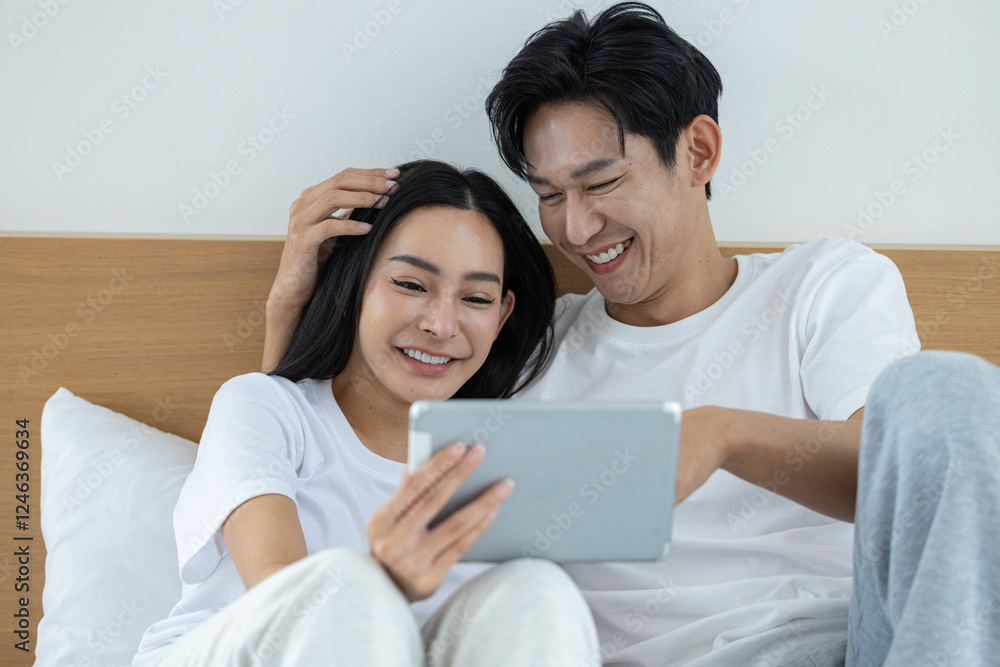 Happy couple watching movies and dramas on the bed Happy couple watching movies and dramas on the bed