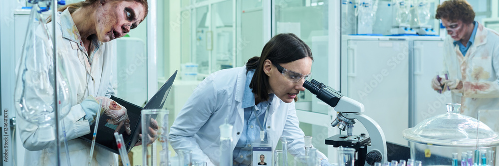 Young Scientist Working In Lab Full Of Zombie Colleagues Header Young Scientist Working In Lab Full Of Zombie Colleagues Header