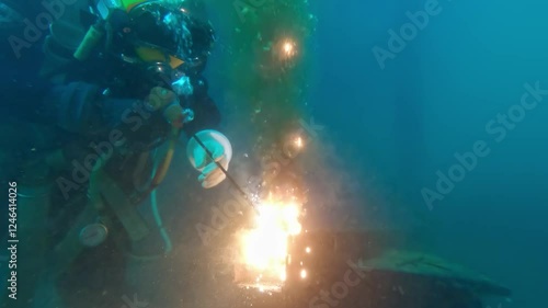 Commercial diver wet welding underwater closeup