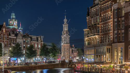 Canvas Print Panoramic night timelapse of Amsterdam city center featuring Amstel River, waterfront and Munttoren tower