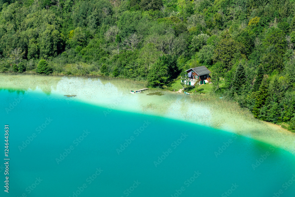 Lone cabin by a lake in the Jura, secluded lake house on the shore, view from Belvedere des Quatres Lacs (Four lakes viewpoint), France