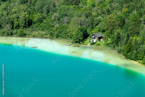 Obraz na płótnie Lone cabin by a lake in the Jura, secluded lake house on the shore, view from Belvedere des Quatres Lacs (Four lakes viewpoint), France w salonie